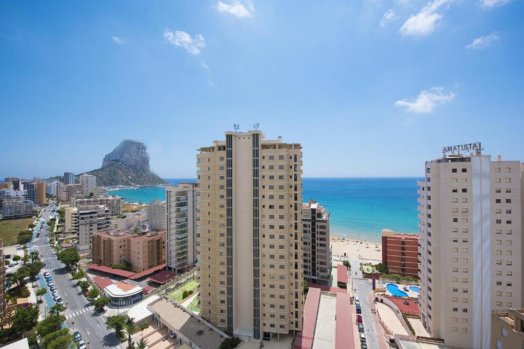a view of a city with a beach and buildings at Apartamento Natsu - PlusHolidays in Calpe