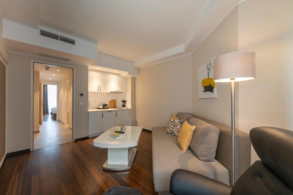 a living room with a couch and a table at Pakat Residences in Vienna
