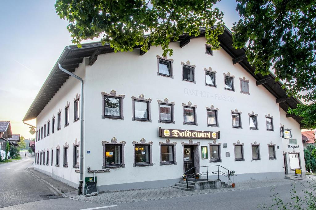 a large white building on the side of a street at Landgasthof Doldewirt in Bernbeuren