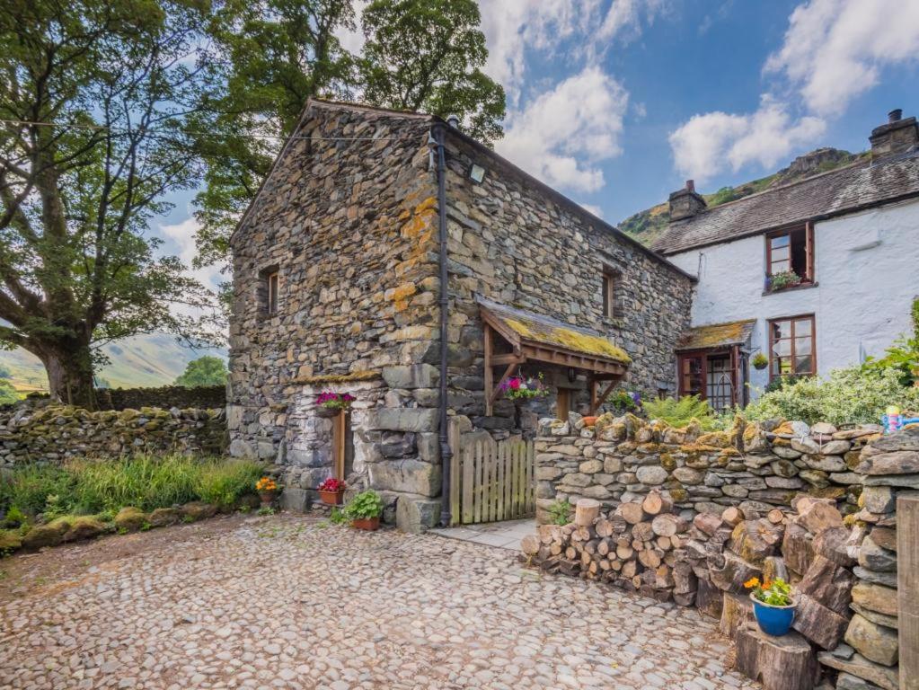 an old stone house with a stone wall at 2 Bed in Patterdale SZ470 in Patterdale