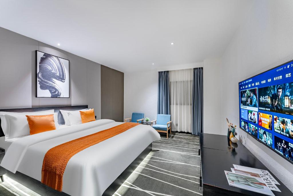 Postel nebo postele na pokoji v ubytování Boyue Miyazaki Hotel - Guangzhou Baiyun International Airport