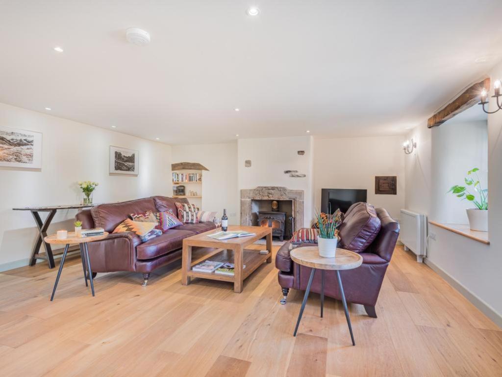 a living room with two couches and a fireplace at 3 Bed in Shap SZ390 in Shap