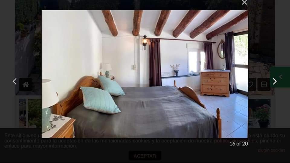 1 dormitorio con 1 cama grande con almohadas azules en Casa Can Emilia, en Tossa de Mar