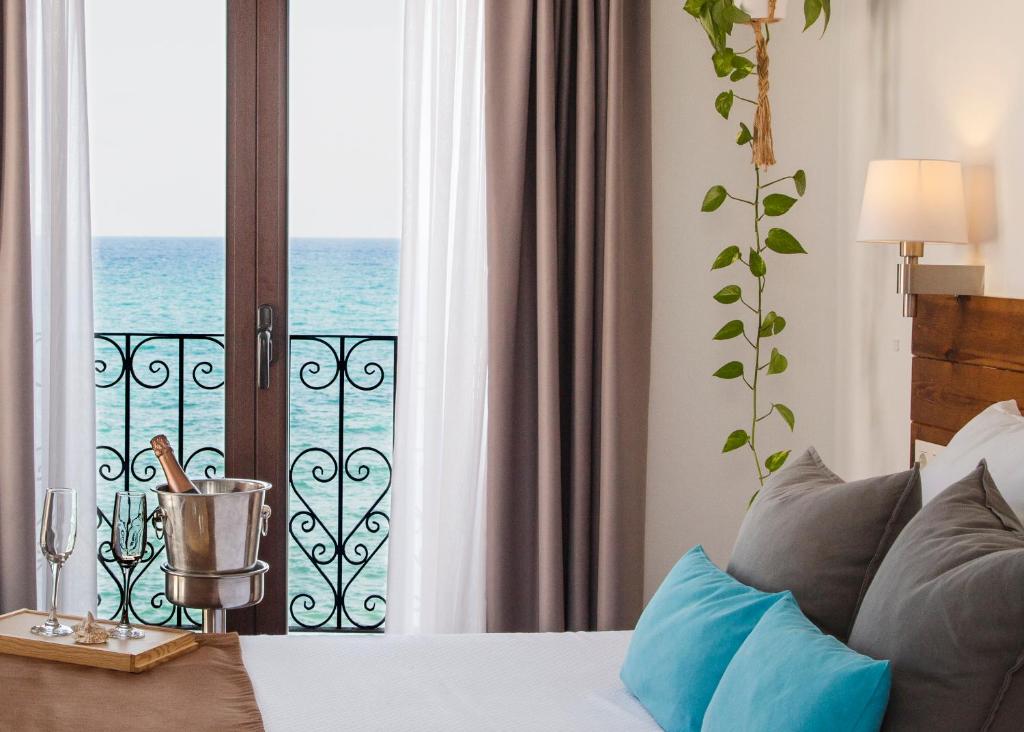 a bedroom with a bed and a view of the ocean at Hostal Boutique Casa del Mar Altea in Altea