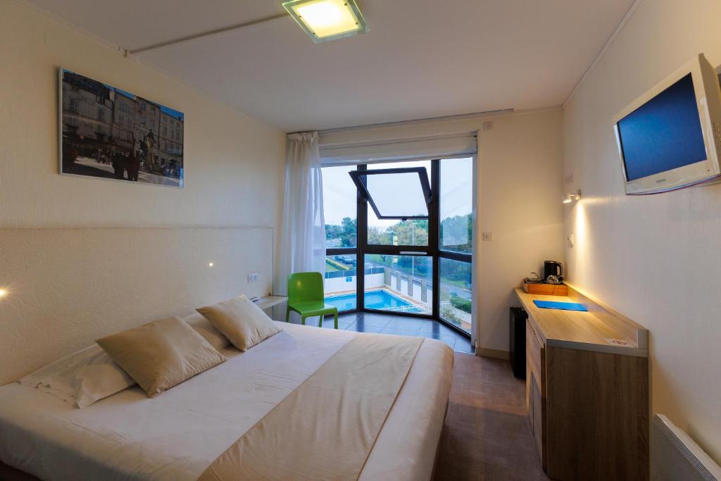 Кровать или кровати в номере Logis Hôtel Le Rochelois
