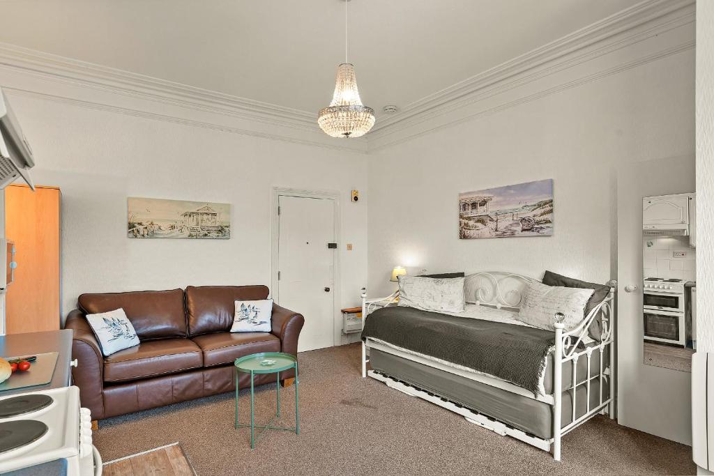 a living room with a bed and a couch at Finest Retreats - Atherfield Apartments No 7 - Sunny Side in Paignton