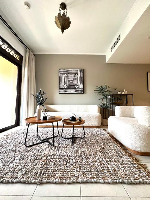 a living room with a couch and a table at SmartApt Elegant 1 BDR Burj view in Dubai