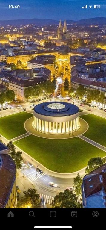 a view of a building in a city at night at B&B President in Zagreb