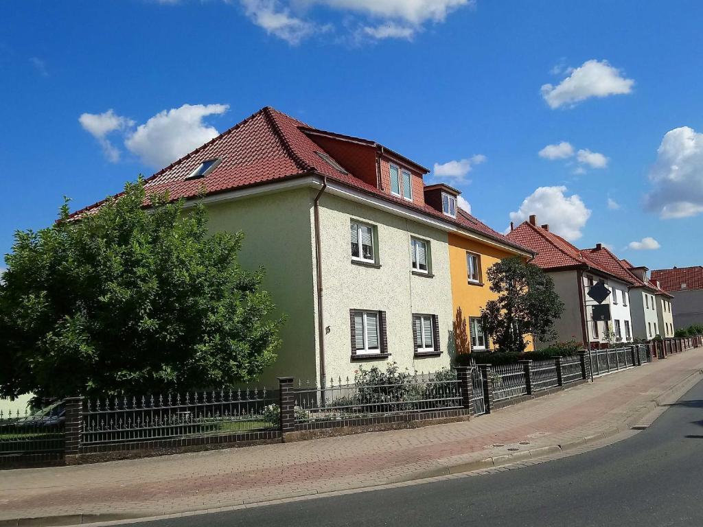 a green and white house with a red roof at Ferienwohnung Grapatin in Teterow