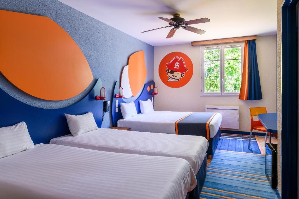 Letto o letti in una camera di Explorers Hotel Marne-la-Vallée