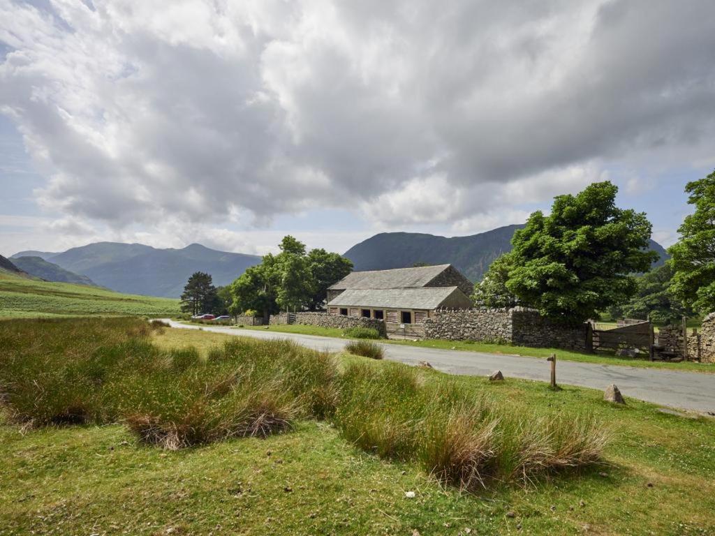 a house on the side of a road with mountains at 2 Bed in Buttermere SZ588 in Buttermere