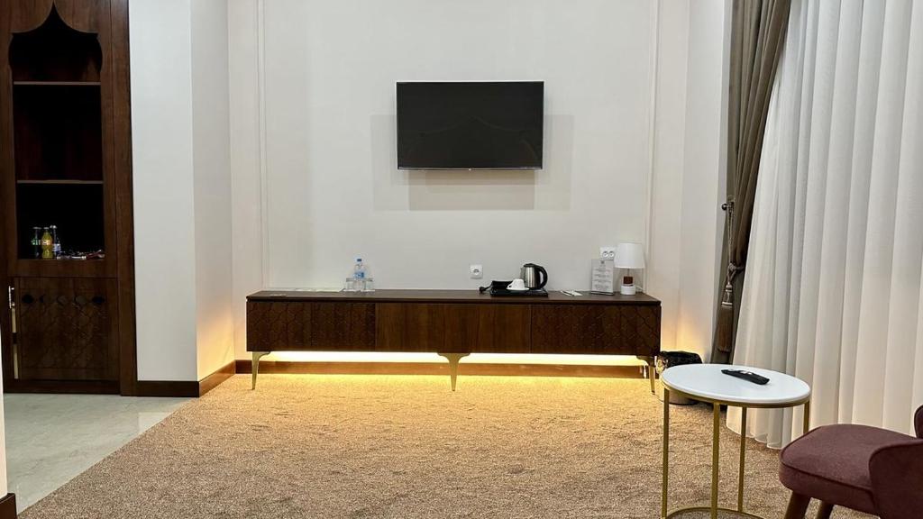 a living room with a flat screen tv on a wall at Reikartz Sote Tashkent in Tashkent
