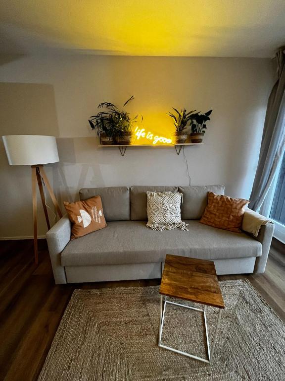 a living room with a couch and a table at BLACKFOREST LOFT - Panoramablick Schwarzwald in Schonach