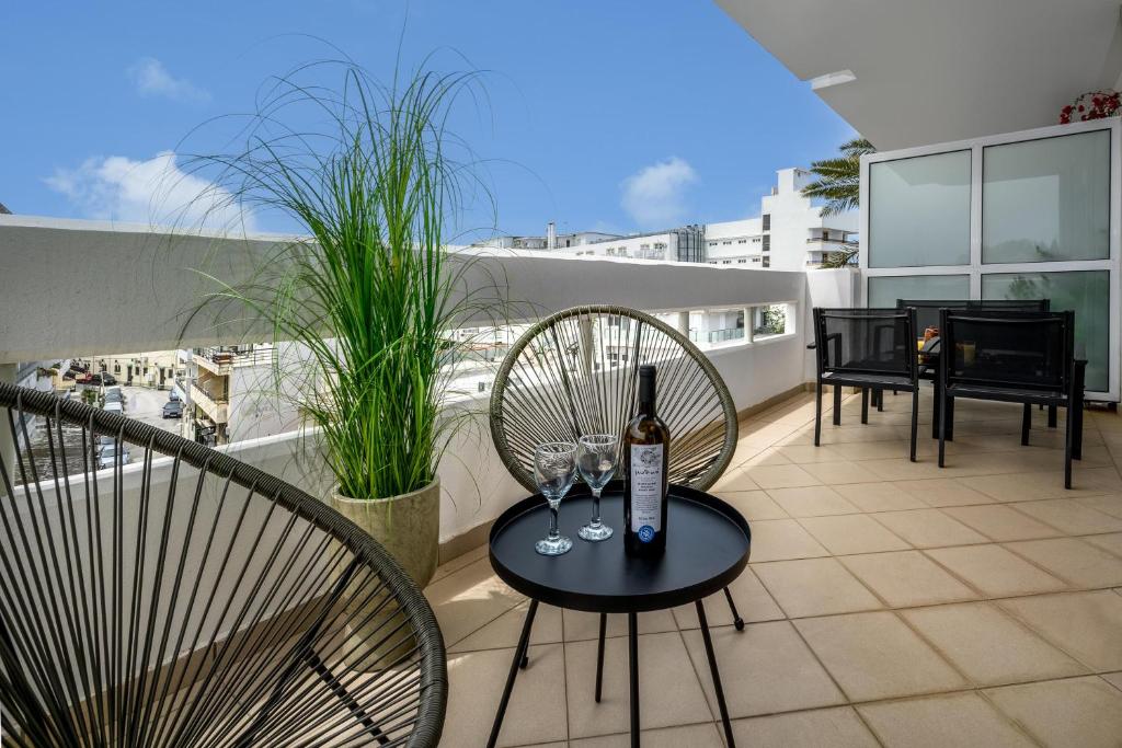 a balcony with a table with a bottle of wine at Elli Beach Downtown Apartments in Rhodes Town