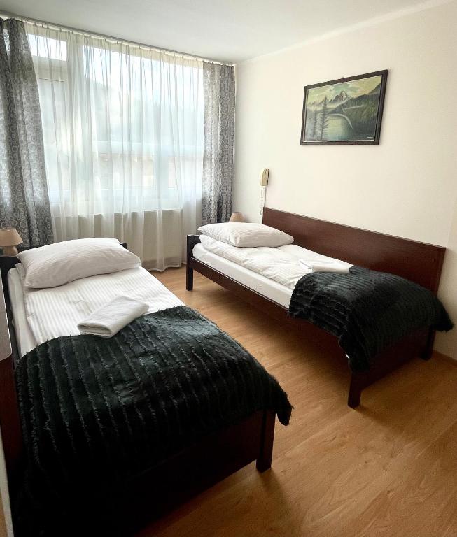 Postel nebo postele na pokoji v ubytování GWAREK Centrum Wypoczynkowe