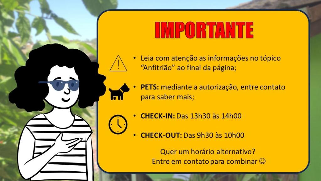 a yellow sign with a woman wearing sunglasses at Chalés em Ilhabela in Ilhabela