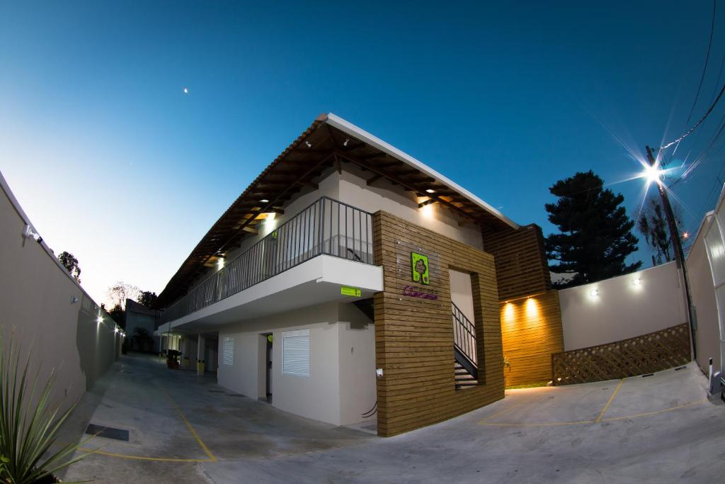 a brick house with a garage in a driveway at Morada Clariana in Curitiba