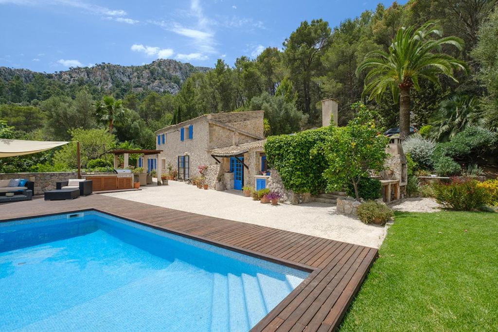 a villa with a swimming pool and a house at Villa Can Ros in Capdellá