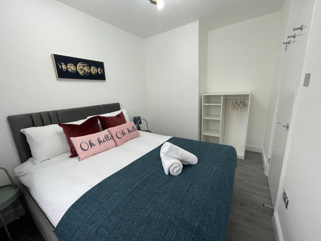 a bedroom with a bed with a pillow on it at Deluxe Apartment - Next to Kings Cross - Eurostar & Euston Station in London