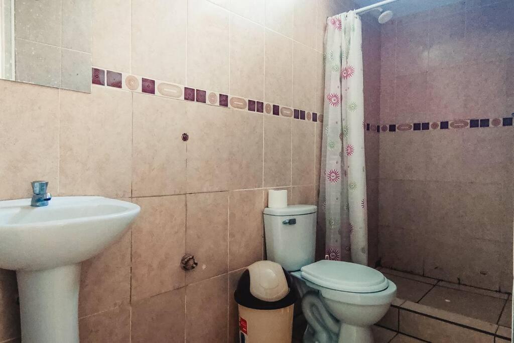 a bathroom with a toilet and a sink at Verano en Boca del Río in La Boca del Río
