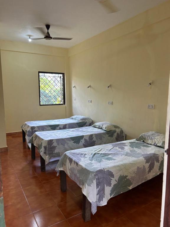 Postel nebo postele na pokoji v ubytování Anjunapalms GuestHouse