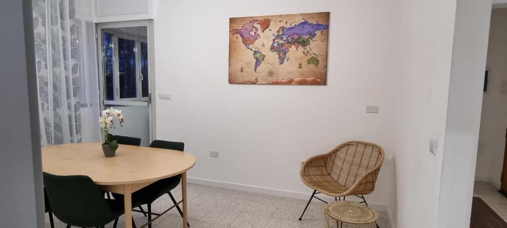 a dining room with a table and a map on the wall at Appartamento Caracas in Rome