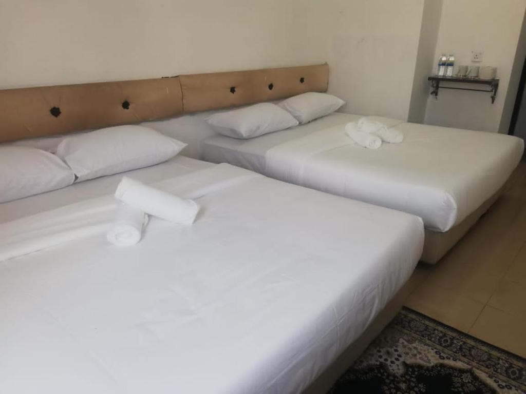 Postel nebo postele na pokoji v ubytování RIYAD HOTEL
