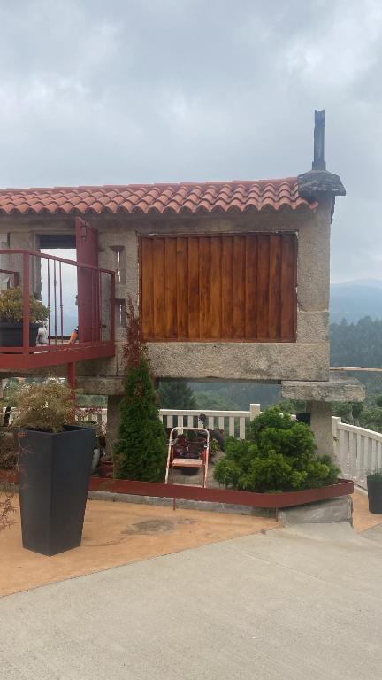 a house with a wooden gate and a patio at Os Fentos in Pontevedra