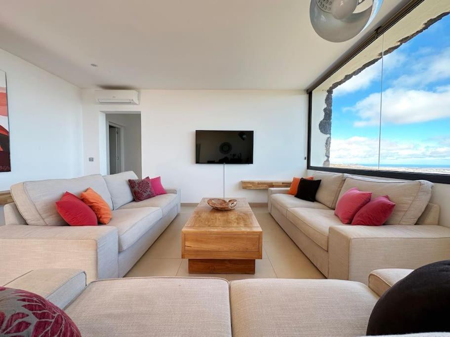 a living room with two couches and a tv at Villa with views and Villaverde in Villaverde