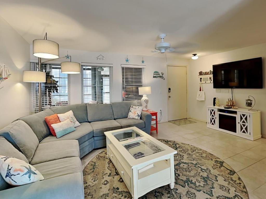 a living room with a couch and a table at Madeira Beach Yacht Club 323b in St Pete Beach