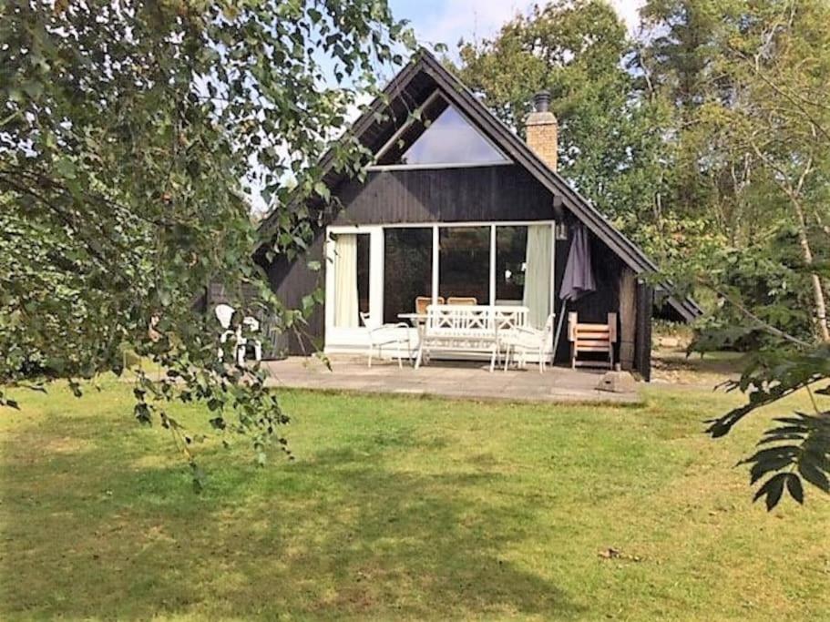 a house with a porch with a table and chairs at Cozy Holiday cottage at Ringkøbing Fjord in Hemmet
