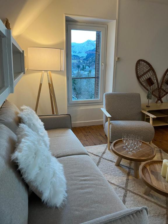 salon z kanapą i oknem w obiekcie NEW : Maison avec vue Montagne w mieście Mont-Dore