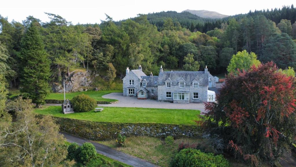 an old house in the middle of a forest at Refurbished Highland Lodge in Spectacular Scenery in Pitlochry