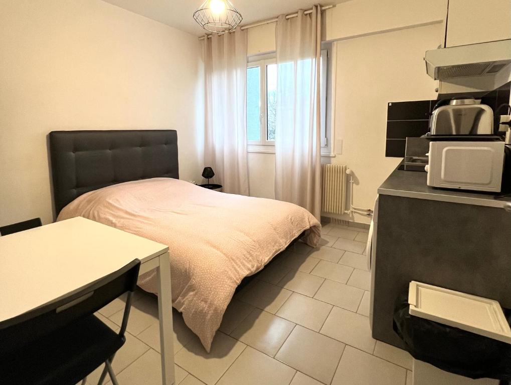 - une chambre avec un lit et un four micro-ondes dans l'établissement Studio tout confort cité de la gastronomie (1), à Dijon