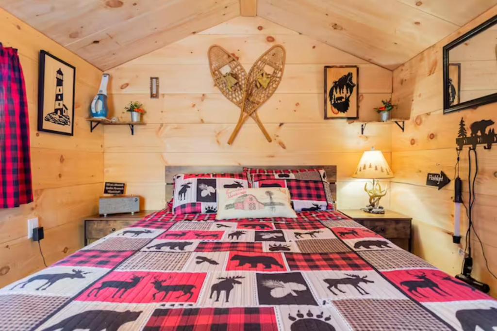 a bedroom with a bed in a log cabin at Shadow Hills farm in Fort Edward