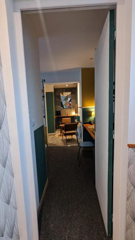 a hallway with a room with a desk and a living room at Aux Écuries Des Pres in Nogent-sur-Seine