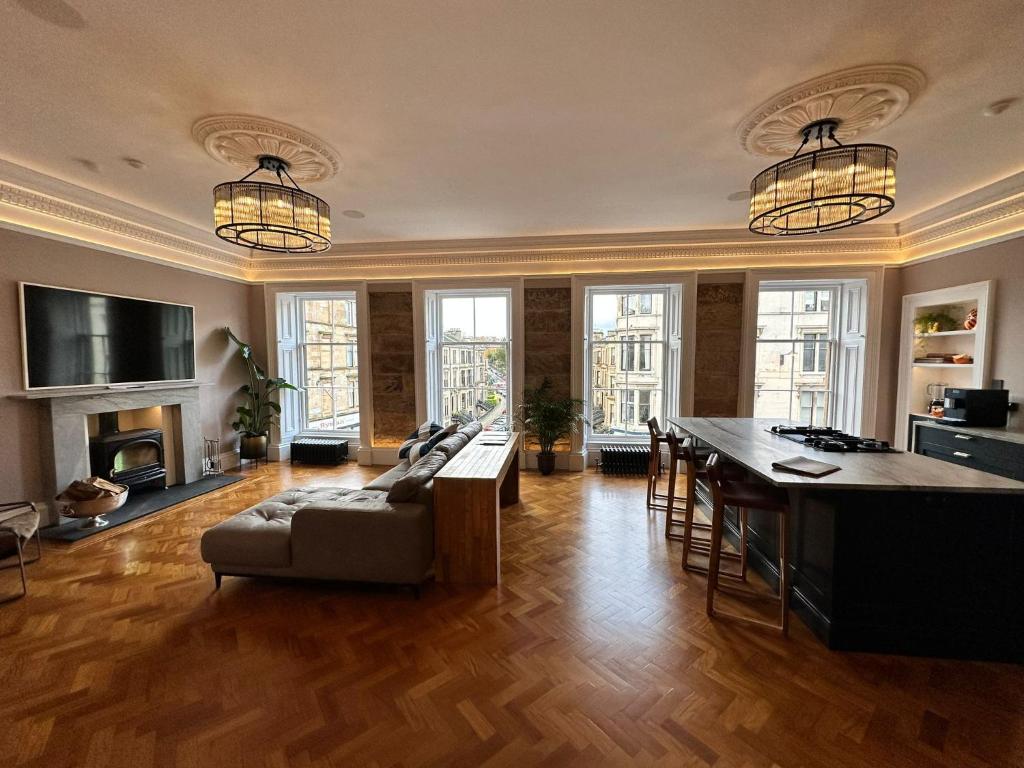 a living room with a couch and a table at Ashton View in Glasgow