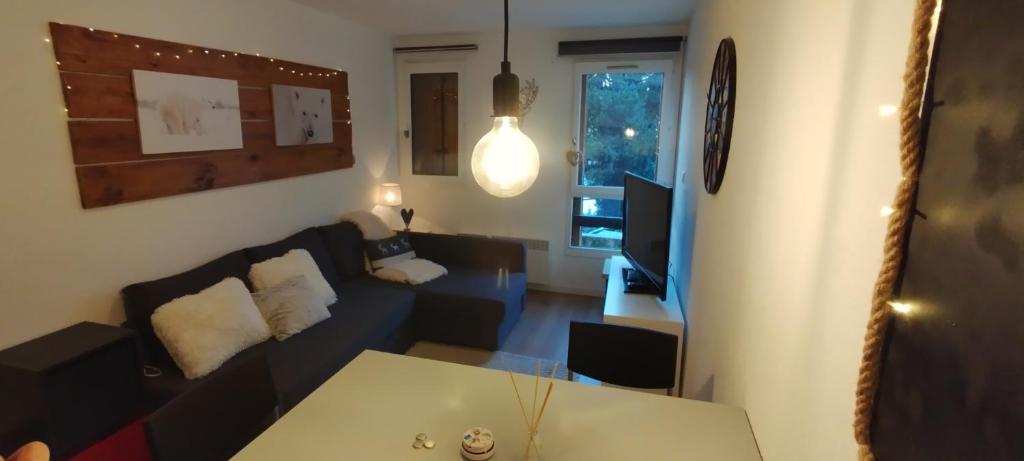 a living room with a couch and a table at STUDIO COSY ISARD P2000 in Bolquere Pyrenees 2000