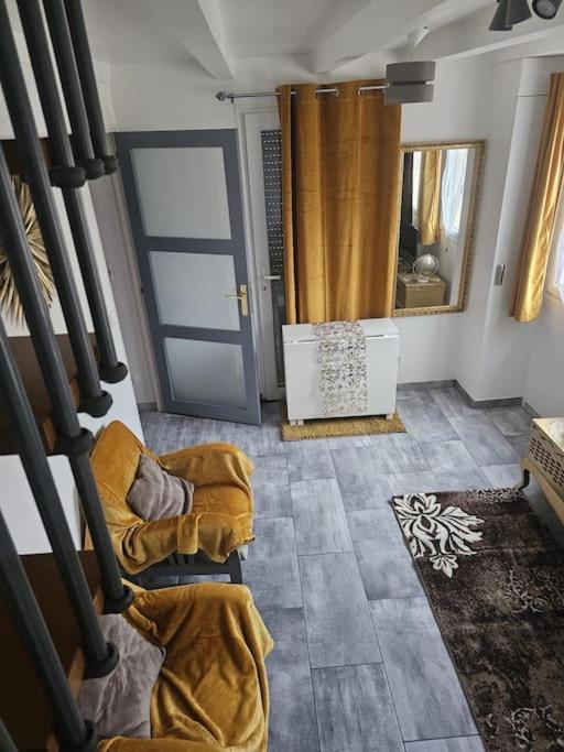 a room with a staircase with chairs and a door at Purple Baroque Rer C -N104-A6 in Brétigny-sur-Orge