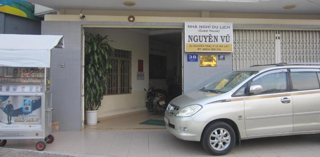 a silver car parked in front of a garage at Nhà Nghỉ Du Lịch Nguyên Vũ in Da Lat