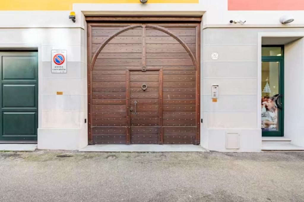 a brown garage door with an arch over it at Lovely apartment with terrace by Alterego in Villanova dʼAsti