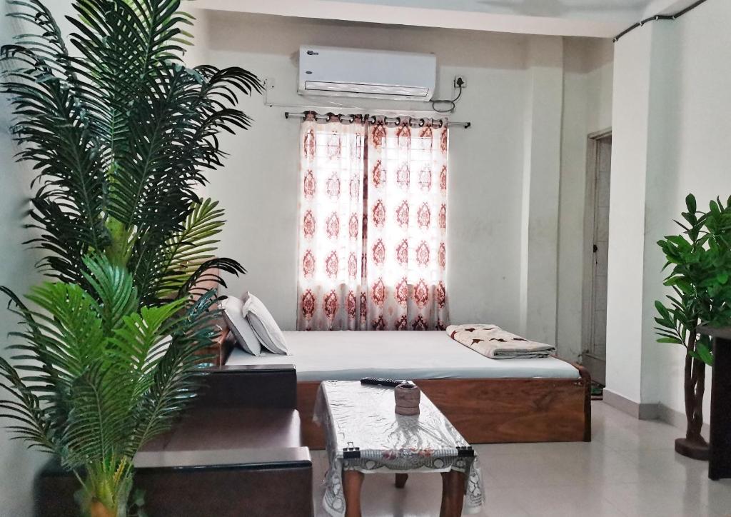 a bedroom with a bed and a potted plant at New Hotel Labbaik in Dhaka