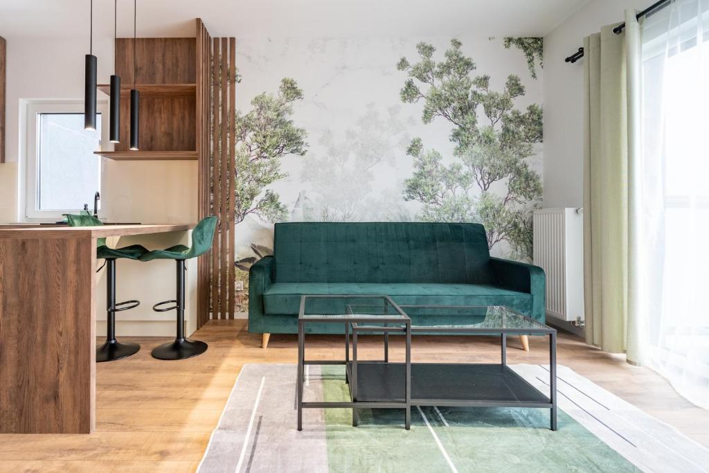 a living room with a green couch and a table at Ceglana Green Studio in Katowice