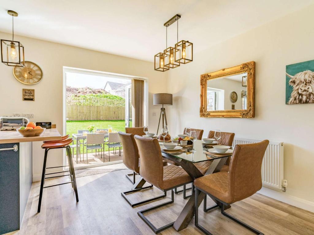 a kitchen and dining room with a table and chairs at 3 Bed in Hackthorpe 86724 in Hackthorpe