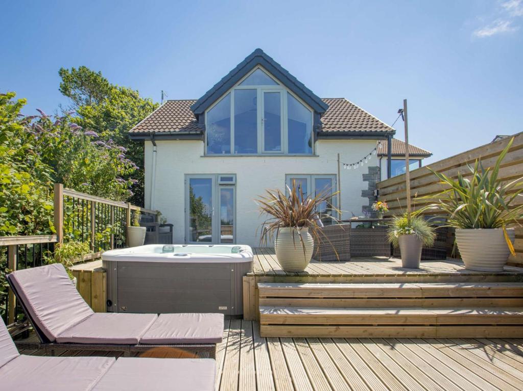 a house with a hot tub on a wooden deck at 2 Bed in Bude 5.6mls N 86909 in Kilkhampton