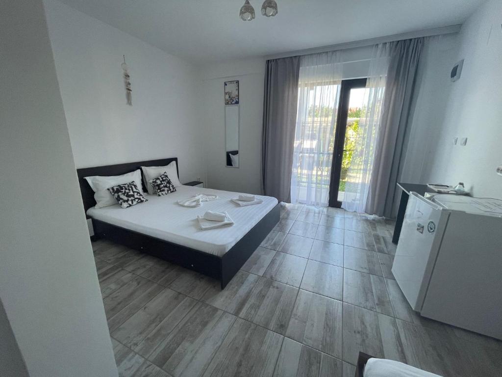 Postel nebo postele na pokoji v ubytování CASA SMARALD