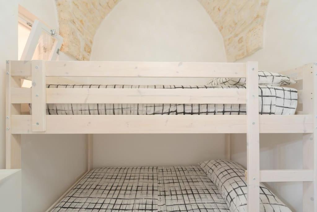 A bed or beds in a room at Le Alcove del Leopardi
