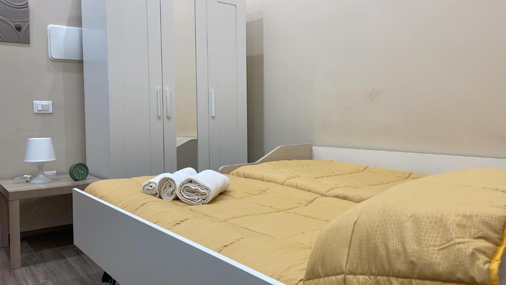 a bed with two pairs of shoes sitting on it at Nonna Concetta B&B Nocera - Vicino Tribunale di Nocera - Ristrutturato 2022 in Nocera Inferiore