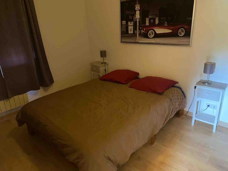 - une chambre avec un lit avec une voiture rouge sur le mur dans l'établissement Très bel appartement 3 pièces + jardin + parking, à Divonne-les-Bains