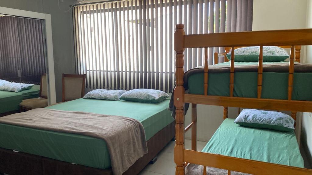 1 dormitorio con 2 literas y ventana en Pousada Ferreira en São Gabriel